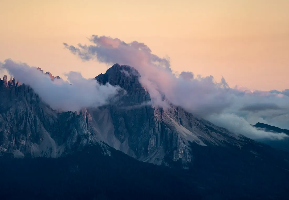 Sunrise over layered mountain peaks, a quiet fantasy landscape